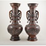 Pair of Chinese bronze vases, archaic form, twin scrolled handles, applied motifs,