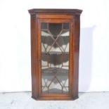 Mahogany hanging corner cupboard, dentil cornice, astragal glazed panel door,