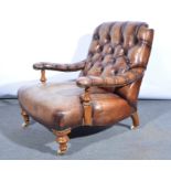 A Gentleman's Edwardian salon armchair, re-upholstered in brown button back leather,