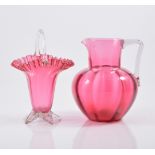 Pair of Cranberry glass wines, height 14cm, three tumblers, two decanters, jug, basket, caster,