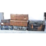 Large painted metal trunk, two canvas bound trunks, tin trunks and suitcases.