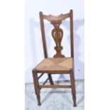 Oak Arts & Crafts style dining chair, pierced vase splat, rush seat, height 102cm.