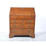 George III oak bureau, fall-front enclosing an interior fitted with drawers,