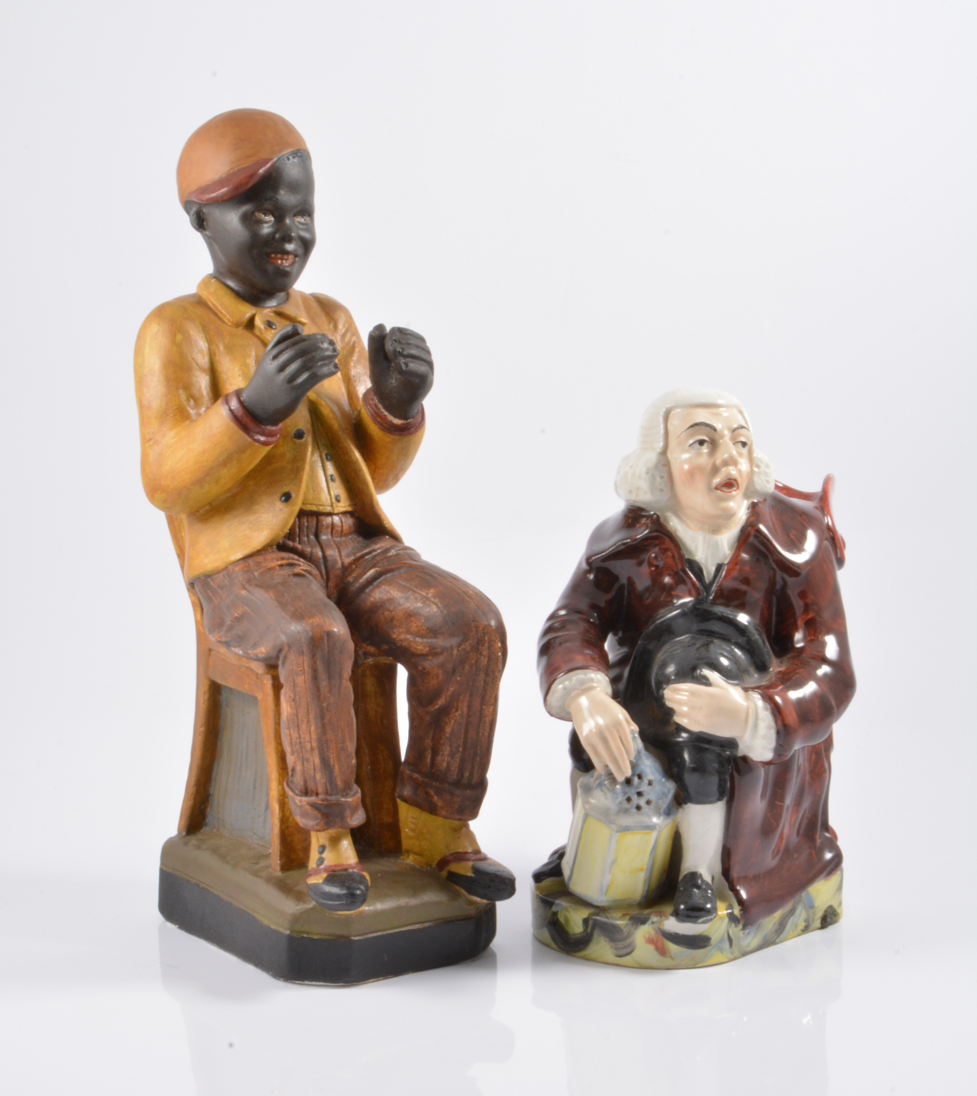 A 19th Century Staffordshire Night Watchman jug, 23cm high and plaster figure of a seated boy 35cm.