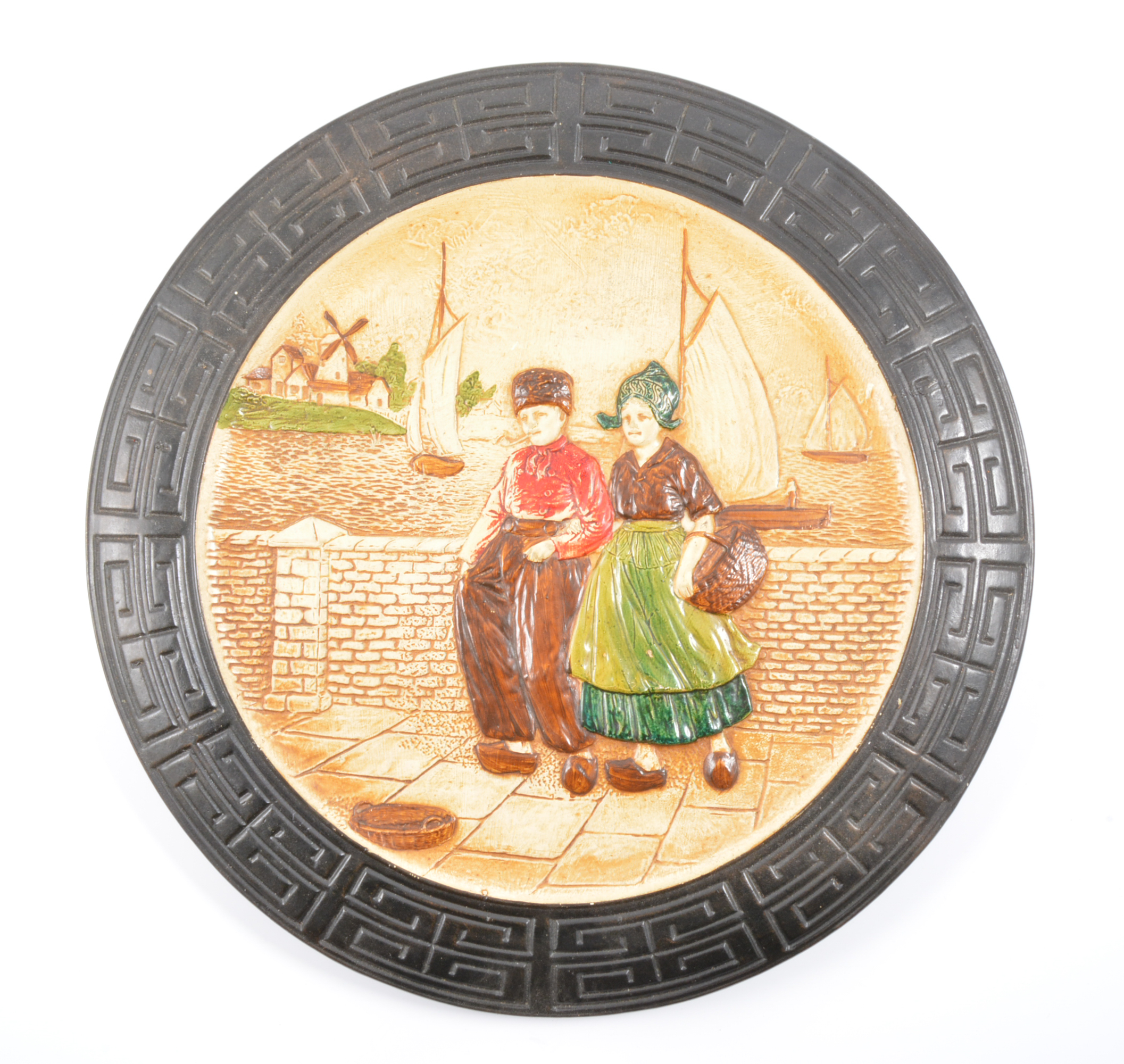 Bretby circular plaque, Dutch figures, diameter 38cm; and two similar oval plaques.