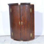 George III oak cylinder front hanging corner cupboard, two doors with crossbanding,