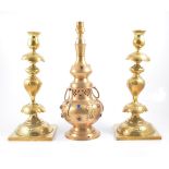 Pair of large pressed brass candlesticks, floral design on square bases,