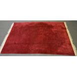 Chinese sculptured wool carpet, magenta coloured, sculptured floral and scroll decoration,