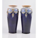 Pair of Royal Doulton stoneware vases, shouldered form, decorated with floral festoons and pendants,