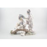 A Lladro group, Figures on a bridge, No. N-1M, oval plinth, 33cm.