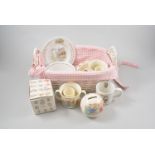 Collection of Royal Doulton Bunnykins Nursery Ware, and other Nursery Ware in a woven cane basket.