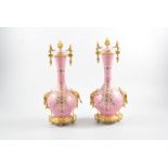 A pair of pink porcelain garniture vases,