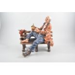 Capodimonte model of a tramp on a bench, 32cm and a Fielding's Crown Devon part dressing table set.