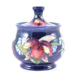 Walter Moorcroft, Orchid, a lidded jar, circa 1950, stamped pottery marks, 14cm high.