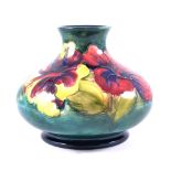 Walter Moorcroft, Hibiscus, a squat vase, circa 1960, initialled in blue, 10.5cm, (restored neck).