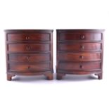 A pair of miniature bow front chests, each with four drawers, bracket feet, 23cm.