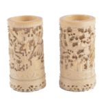 A pair of Cantonese pierced and carved ivory vases, each of cylindrical form,