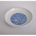 WITHDRAWN Chinese saucer dish, interior decorated in blue and white with a dragon,
