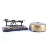 A 14cm brass table bell with hammer, set of brass postal scales and weights, other cast weights,