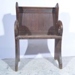 Oak choir seat, panelled back, carved sides, boarded seat, width 64cm.