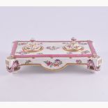 An English pottery inkstand, rectangular form, painted with flowers, fitted with two wells, 22cm.