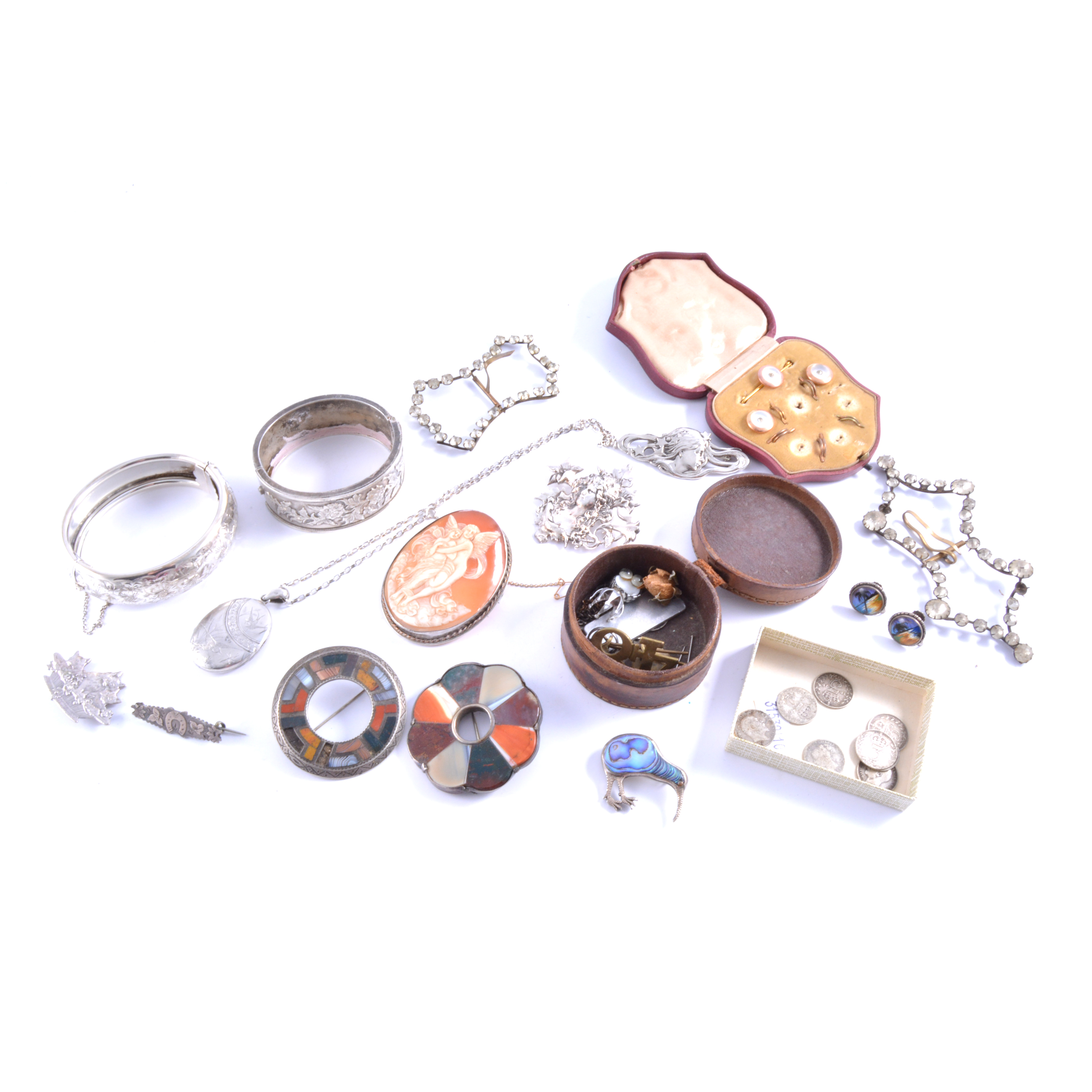 Two silver half hinged bangles, agate brooches, an oval carved shell cameo brooch,