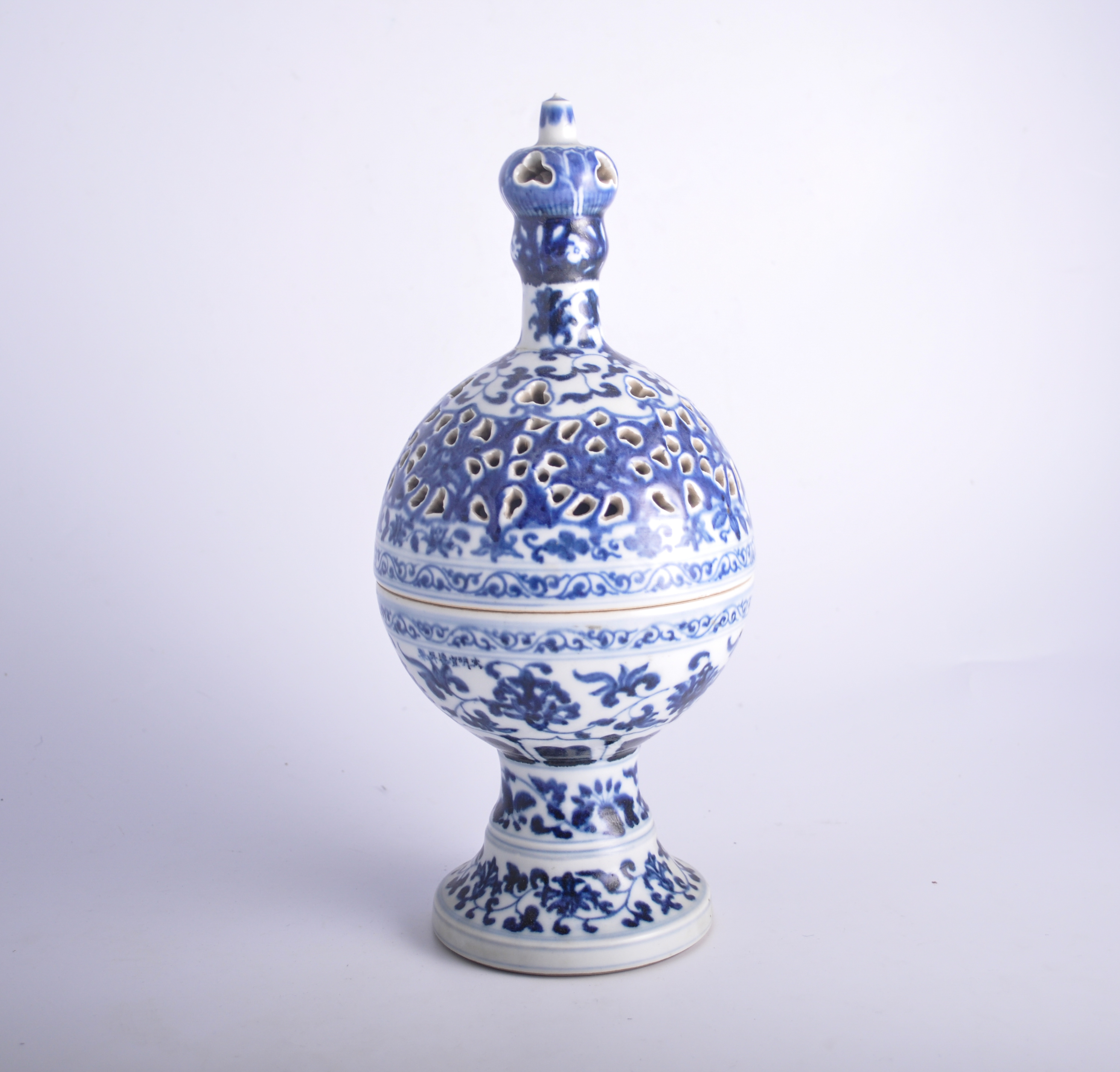 Chinese blue and white reticulated censer, of sphere and pedestal form, floral decoration, 33cm.