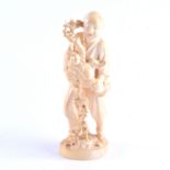 A Japanese carved ivory okimono, a man and boy holding a fruiting vine, Meiji, two character mark,