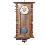 An oak cased wall clock the roman numeral chapter having a moulded pictorial centre of two birds,