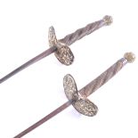 A pair of early French foils by Souzy, Paris, brass pommels and pierced shell guards,