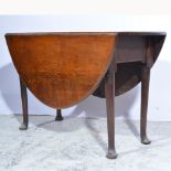 Oak gateleg table, oval top with two fall leaves, turned legs, pad feet, the top 113cm x 135cm,