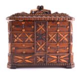 A large carved wooden jewel box with some costume jewellery, smaller wooden caskets,