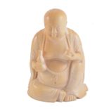 A carved ivory figure, Buddha seated holding a gourd, 10cm.