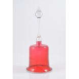 A cranberry glass bell with vaseline glass rim and clear handle, 36cm high (missing clapper).