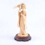 A Japanese carved ivory okimono, a Geisha holding a parasol, two character mark, 23cm.