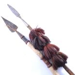 Two African spears, broad leaf-shape blades, short wooden shaft, the base with long spikes,