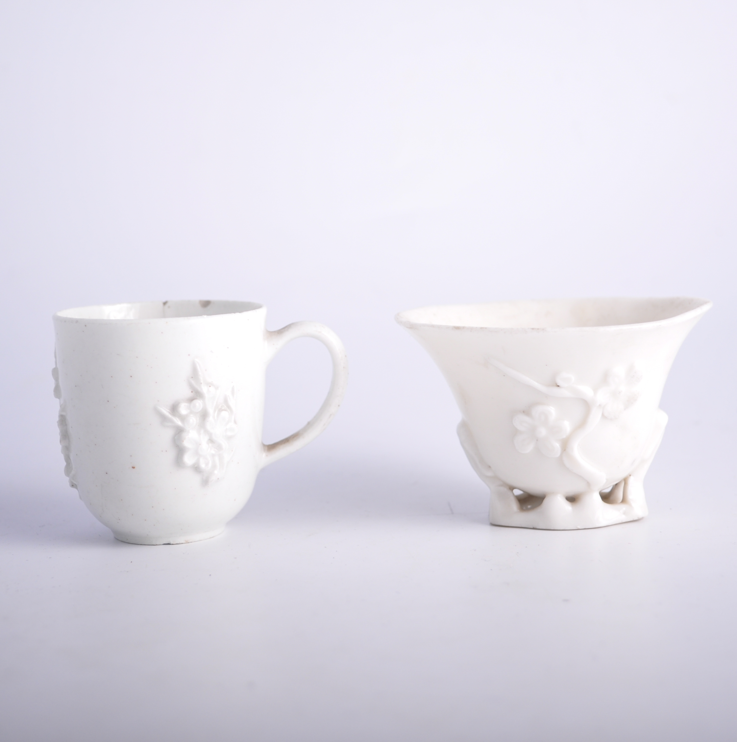 Chinese Blanc de Chine libation cup, moulded with sprigs, 6cm; and Blanc de Chine cup.
