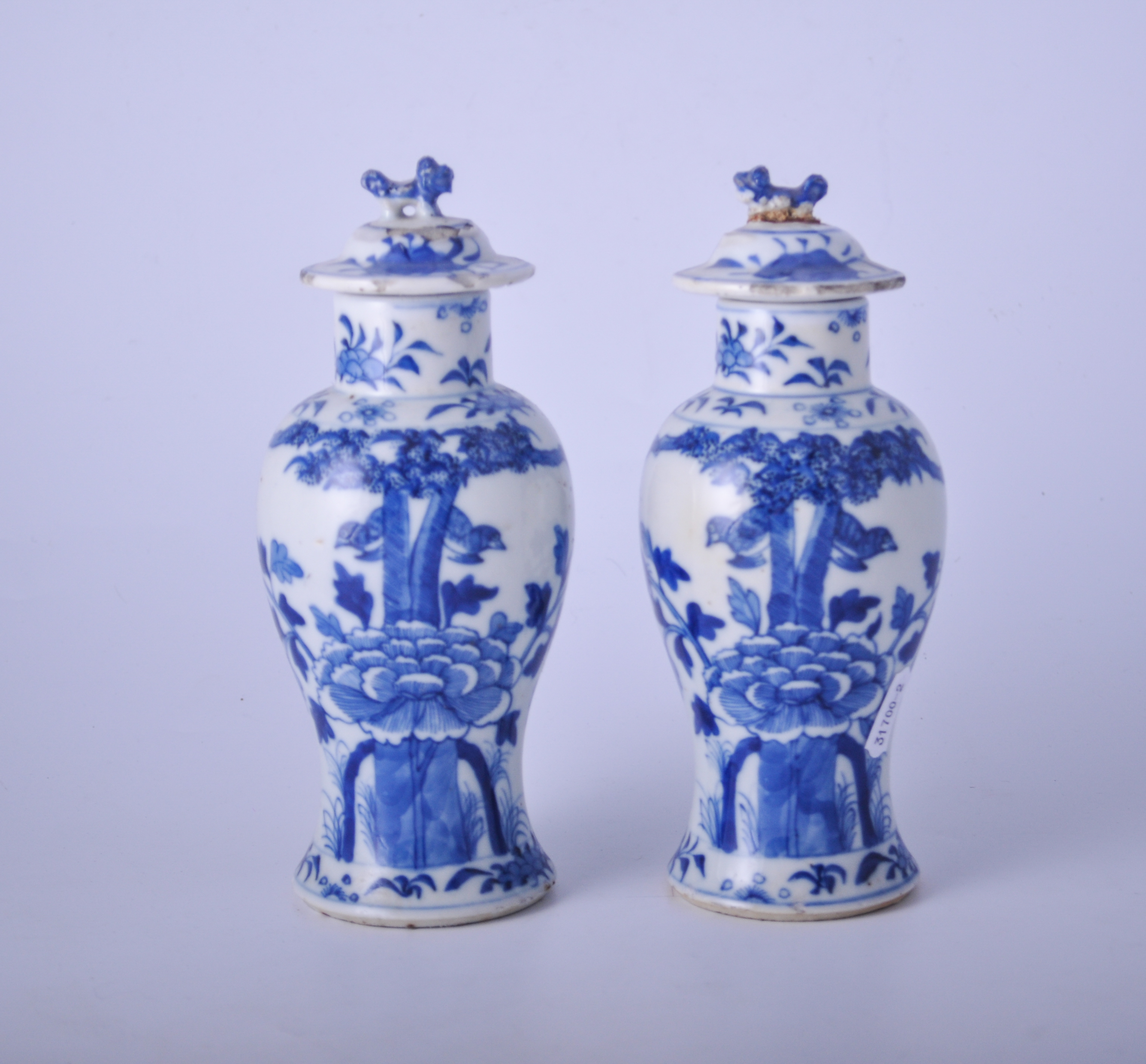 Pair of Chinese blue and white covered vases, baluster form, decorated with birds and foliage,