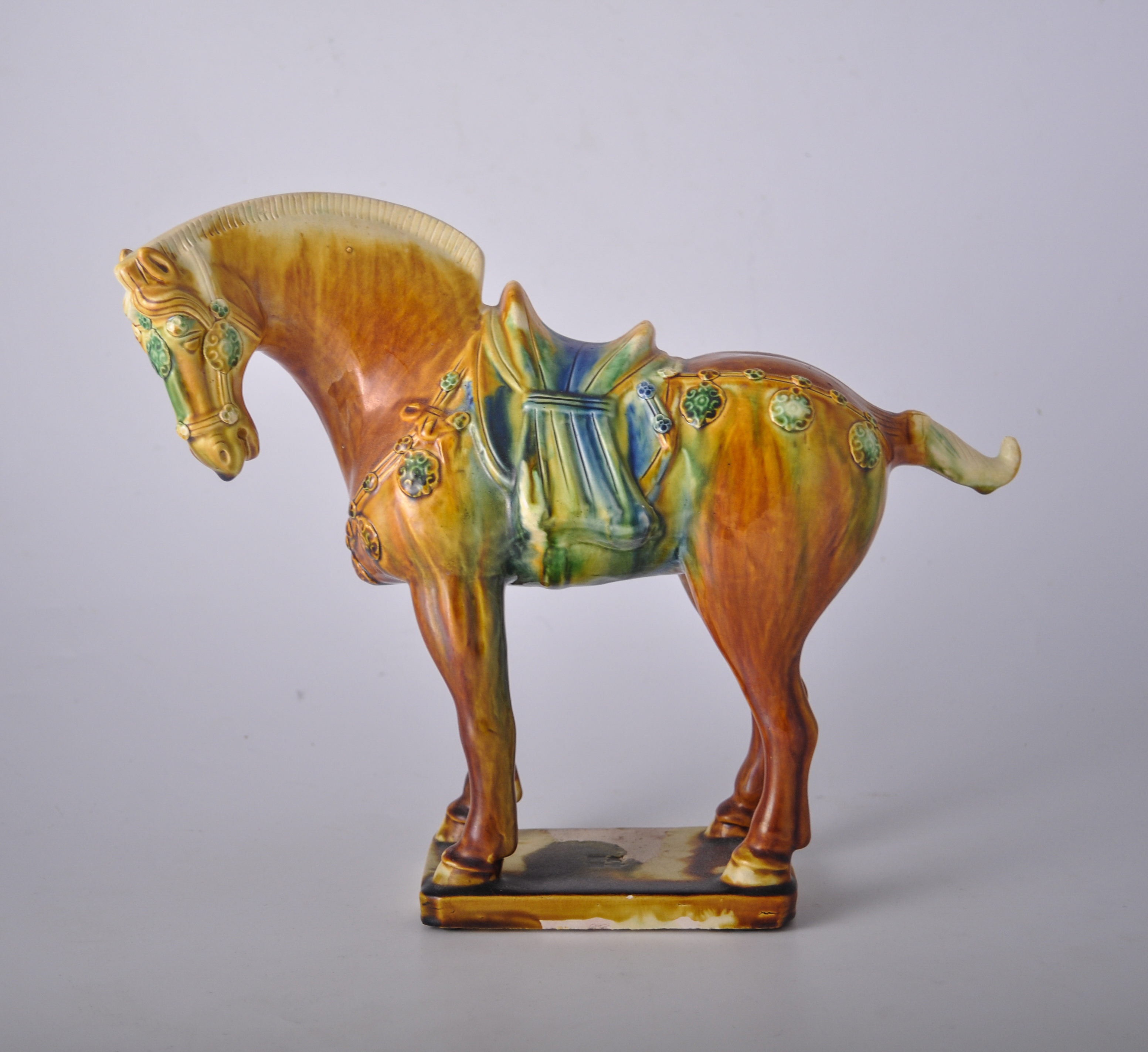 Tang style glazed stoneware horse, plinth with impressed mark, 26cm.