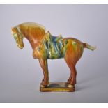 Tang style glazed stoneware horse, plinth with impressed mark, 26cm.