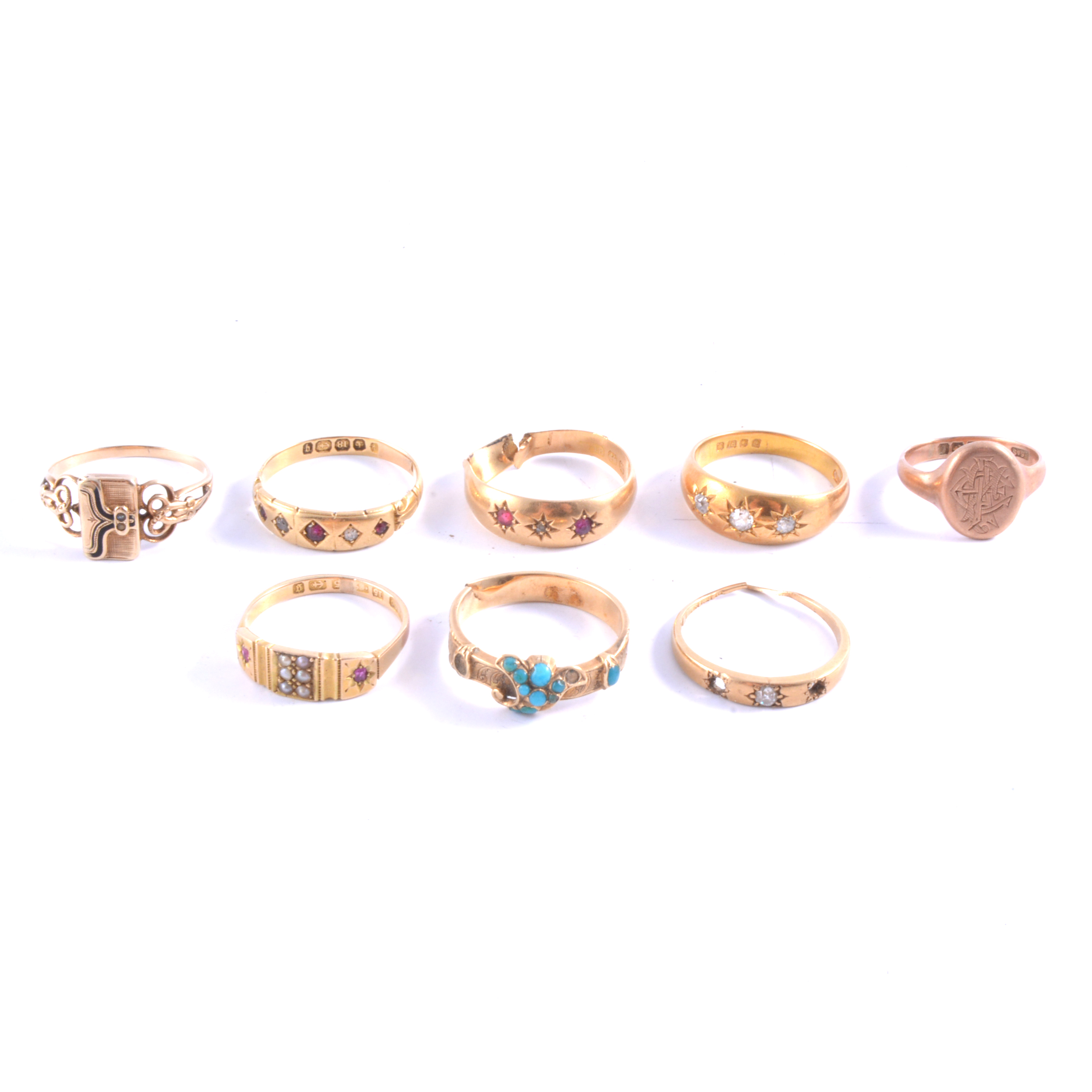 Eight gold rings, an 18 carat yellow gold gypsy set three stone old cut diamond ring,