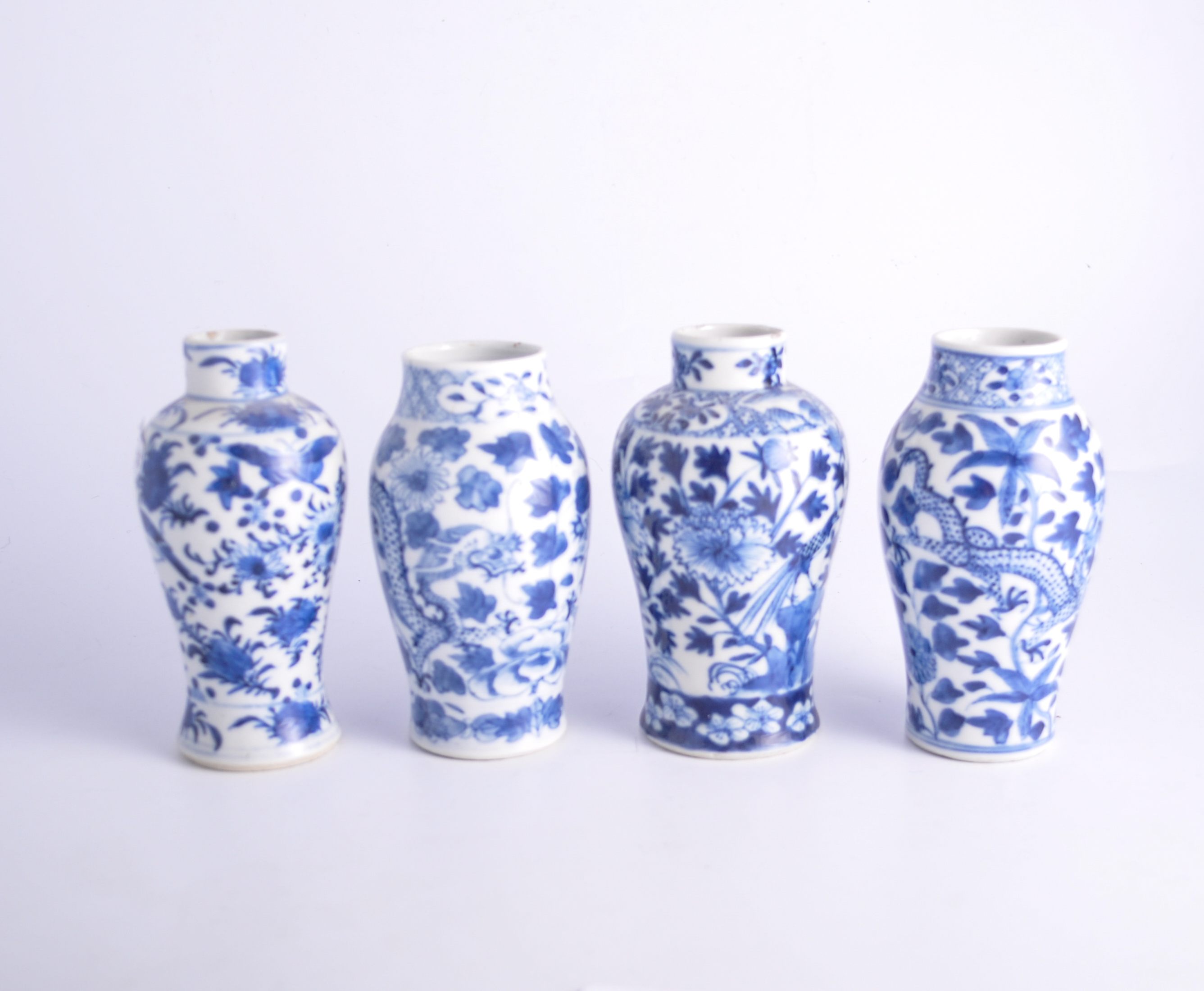 Two similar blue and white shouldered vases, bearing Kangxi four-character marks,