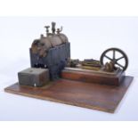 A well built stationary engine, mounded on wooden base, with 4inch flywheel, 35cm by 27cm base.