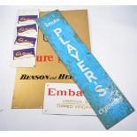 Cadburys tin sign, together with Embassy, Benson & Hedges, and other cigarette tin signs.