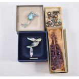 Two Swarovski brooches, costume jewellery; silver bracelet and ring; lorgnette.