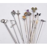 A collection of fourteen Edwardian hat pins, including Scottish thistle designs,