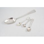 Georgian silver basting spoon, and three other silver spoons.