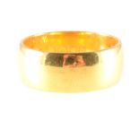 A 22 carat yellow gold wedding band, plain polished 7.7mm wide D shape, approximate weight 9.