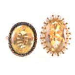 Two citrine dress rings, one having an oval mixed cut citrine 20mm x 12mm,