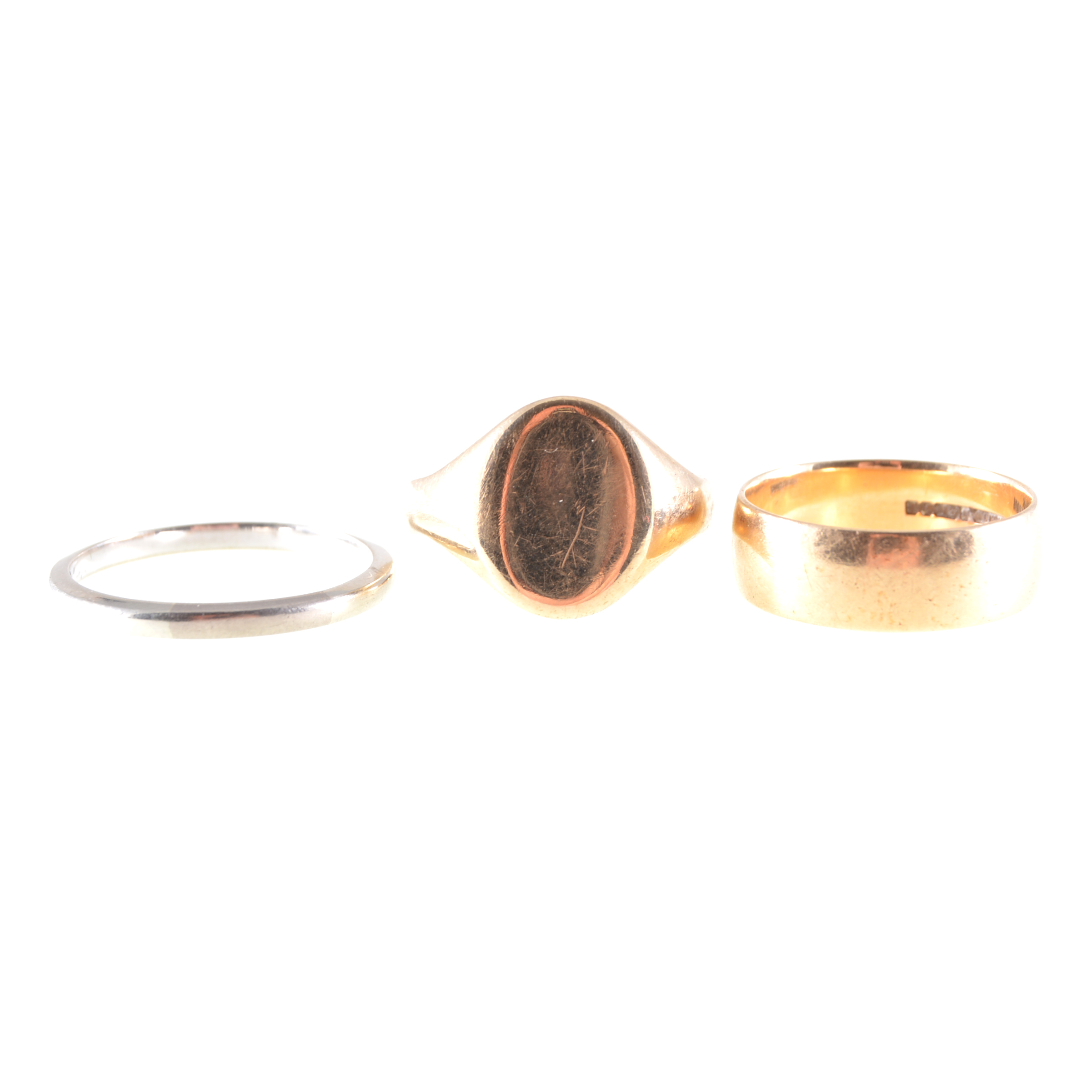 Three gold rings, an 18 carat white gold wedding band, 2.1mm wide, approximate weight 3.